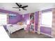 A pink and purple bedroom, with bed, lighting, and posters at 4000 Bridgewood Ln, Charlotte, NC 28226