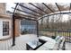 Rear covered deck area with outdoor seating, ceiling fan, and outdoor scenery at 4000 Bridgewood Ln, Charlotte, NC 28226