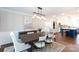 Dining room open to kitchen with hardwood floors and modern light fixture at 4000 Bridgewood Ln, Charlotte, NC 28226