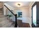 Welcoming foyer with a staircase, hardwood floors, and an open view to the living room at 4000 Bridgewood Ln, Charlotte, NC 28226