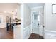 Hallway leading to a kitchen with an island and a separate bathroom at 4000 Bridgewood Ln, Charlotte, NC 28226