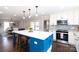 Modern kitchen with a blue island, white cabinets, and open view to a dining room at 4000 Bridgewood Ln, Charlotte, NC 28226