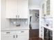 Kitchen area features white cabinetry, a marble backsplash, and wine storage at 4000 Bridgewood Ln, Charlotte, NC 28226