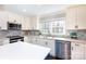 Bright kitchen features stainless steel appliances, herringbone backsplash and white cabinets at 4000 Bridgewood Ln, Charlotte, NC 28226