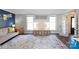 Bright living room featuring hardwood floors, a decorative rug, and large windows that let in natural light at 4000 Bridgewood Ln, Charlotte, NC 28226