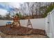 Backyard featuring a wooden playset and a cozy firepit area at 4075 Creekstone Trce, Gastonia, NC 28056