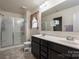 Bathroom with double sink vanity, toilet, and glass enclosed shower at 4075 Creekstone Trce, Gastonia, NC 28056