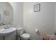 Neutral bathroom with a pedestal sink, toilet, and decorative art at 4075 Creekstone Trce, Gastonia, NC 28056