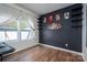 Stylish bedroom featuring a black accent wall, unique decor, and natural light from a window at 4075 Creekstone Trce, Gastonia, NC 28056