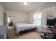 Neutral bedroom with a large window, computer, and a view into another living space at 4075 Creekstone Trce, Gastonia, NC 28056