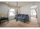 Versatile loft space with neutral walls, plush carpet, a sofa, and natural light from a window at 4075 Creekstone Trce, Gastonia, NC 28056