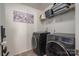 Laundry room with black front load washer and dryer at 4075 Creekstone Trce, Gastonia, NC 28056