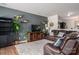 Comfortable living room featuring a plush leather sofa, modern decor, and lots of natural lighting at 4075 Creekstone Trce, Gastonia, NC 28056