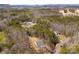 An aerial view highlights the home's location within a wooded community and views of the distant mountains at 433 Cornerstone Dr, Taylorsville, NC 28681