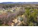 An aerial view showcasing this home's setting amongst the trees in a rural setting, with houses nearby at 433 Cornerstone Dr, Taylorsville, NC 28681