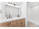 This bathroom has a double sink vanity with wood cabinets, black hardware and a walk-in shower at 433 Cornerstone Dr, Taylorsville, NC 28681