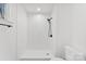 Walk-in shower features white subway tile and a black shower head and a toilet in the corner at 433 Cornerstone Dr, Taylorsville, NC 28681