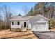 Charming single-story home featuring a two-car garage, a welcoming porch, and a well-manicured front yard at 433 Cornerstone Dr, Taylorsville, NC 28681