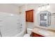 Bathroom featuring shower-tub combo, storage cabinet, and granite-topped vanity at 485 Sutro Forest Nw Dr, Concord, NC 28027