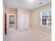 A well-lit bedroom with neutral walls, white trim, and a closet at 485 Sutro Forest Nw Dr, Concord, NC 28027