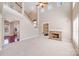 Bright living room with stone fireplace, built-in shelving, and stairs to upper level at 485 Sutro Forest Nw Dr, Concord, NC 28027