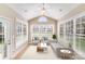 Sun-drenched sun room featuring large windows, ceiling fan, and tile flooring at 485 Sutro Forest Nw Dr, Concord, NC 28027