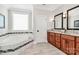 Elegant bathroom featuring a soaking tub, double vanity, and modern fixtures at 5086 Windward Point Ln, Denver, NC 28037