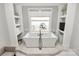 Luxurious soaking tub with serene water views, creating a peaceful retreat for relaxation in a spa-like setting at 5086 Windward Point Ln, Denver, NC 28037