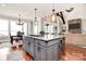 Spacious kitchen island with granite countertops, stainless steel appliances, and an open view to the living room at 5086 Windward Point Ln, Denver, NC 28037