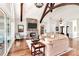 Open concept living area with stone fireplace, exposed beams, and bright lighting at 5086 Windward Point Ln, Denver, NC 28037