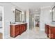 Stylish main bathroom with double vanities, marble floors, and a glass-enclosed shower, providing a modern and elegant space at 5086 Windward Point Ln, Denver, NC 28037