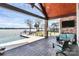 Outdoor patio features a beautiful swimming pool, lake views, and comfortable seating at 5086 Windward Point Ln, Denver, NC 28037