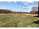 Large, grassy backyard provides ample space for recreation and enjoying the outdoors at 515 Panhandle Rd, Gold Hill, NC 28071