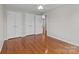 Bedroom featuring hardwood floors, closet, and neutral paint at 515 Panhandle Rd, Gold Hill, NC 28071