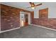 Bonus room with brick accent wall, ceiling fan, and access to kitchen at 515 Panhandle Rd, Gold Hill, NC 28071