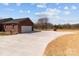 Long, paved driveway leading to a spacious two-car garage with ample parking space at 515 Panhandle Rd, Gold Hill, NC 28071