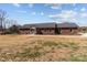 Charming brick home with a well-maintained lawn and metal roof offers great curb appeal at 515 Panhandle Rd, Gold Hill, NC 28071