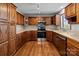 A modern kitchen features stainless steel appliances, warm wood cabinets, and ample counter space at 515 Panhandle Rd, Gold Hill, NC 28071