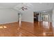 Bright open-concept living room with hardwood floors, a ceiling fan, and access to kitchen at 515 Panhandle Rd, Gold Hill, NC 28071