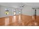 Bright and airy living room features hardwood floors, ceiling fan, and a doorway leading to other spaces at 515 Panhandle Rd, Gold Hill, NC 28071