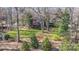 Aerial view of a backyard featuring a patio, lawn, and trees for outdoor enjoyment at 5213 Wood Lake Dr, Belmont, NC 28012