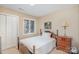 Cozy bedroom with neutral paint, a wood-framed single bed, and a traditional-style dresser at 5213 Wood Lake Dr, Belmont, NC 28012