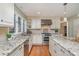 Kitchen with stainless steel appliances, granite countertops, and white cabinetry at 5213 Wood Lake Dr, Belmont, NC 28012