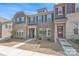 Charming two-story townhome featuring a brick facade and stylish architectural details at 5341 Orchid Bloom Dr # 55, Fort Mill, SC 29707