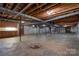 Unfinished basement with exposed beams, concrete floor, and existing utilities, ready to be customized at 5830 W Nc 10 Hwy, Hickory, NC 28602