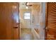 Tidy bathroom features tiled walls, a shower, and natural light from the window at 5830 W Nc 10 Hwy, Hickory, NC 28602