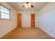 Bedroom featuring neutral walls, carpet flooring, a window, and two wood doors at 5830 W Nc 10 Hwy, Hickory, NC 28602