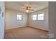 Bedroom featuring carpet, neutral walls, two windows, and a ceiling fan at 5830 W Nc 10 Hwy, Hickory, NC 28602