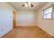 Bedroom featuring carpet, neutral walls, a window, and a door at 5830 W Nc 10 Hwy, Hickory, NC 28602