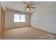 Bright bedroom with neutral carpet, a ceiling fan and ample closet space at 5830 W Nc 10 Hwy, Hickory, NC 28602